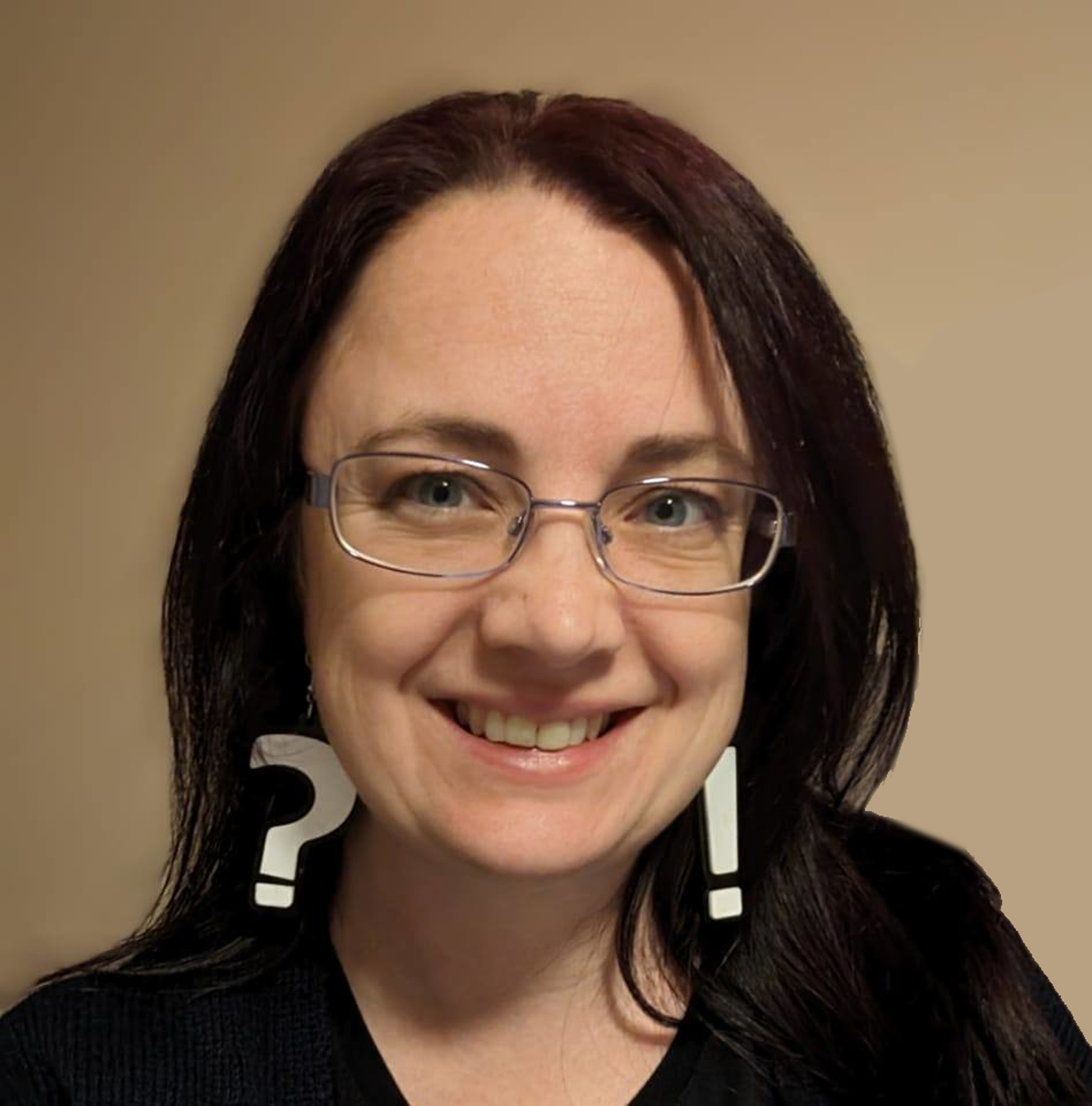 The picture shows a headshot of a woman called Holly Marlow. It shows her from shoulders up and she has shoulder length dark hair, classes and large question mark earrings.