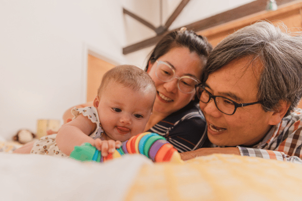 Couple with baby, playing